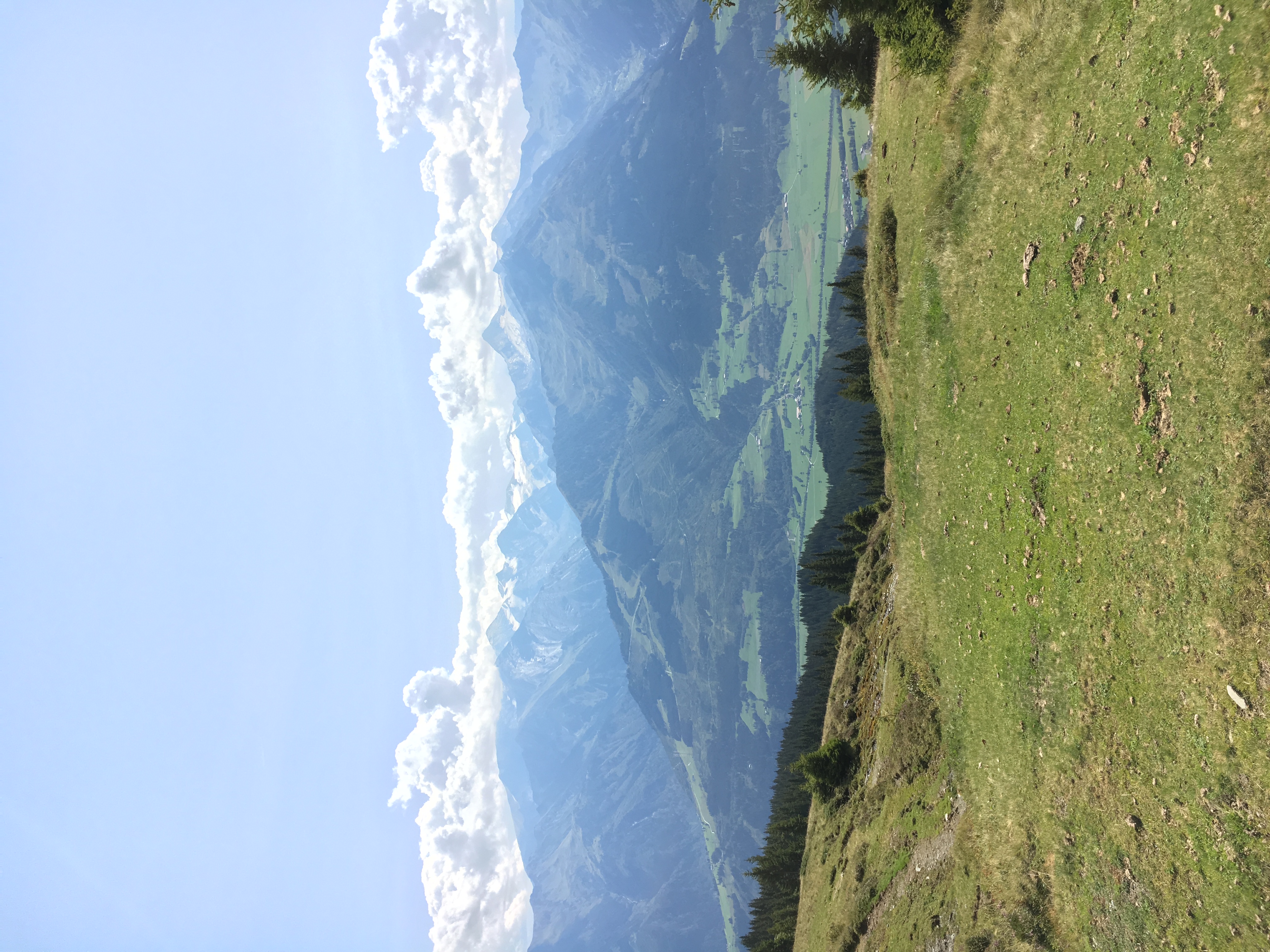 A stone cairn marking the trail in soft mountain mist
